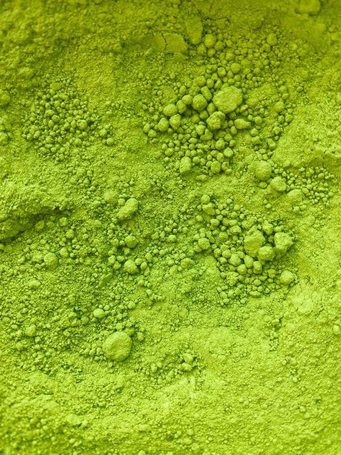 Detailed close-up of vibrant green matcha powder showcasing texture and granularity.